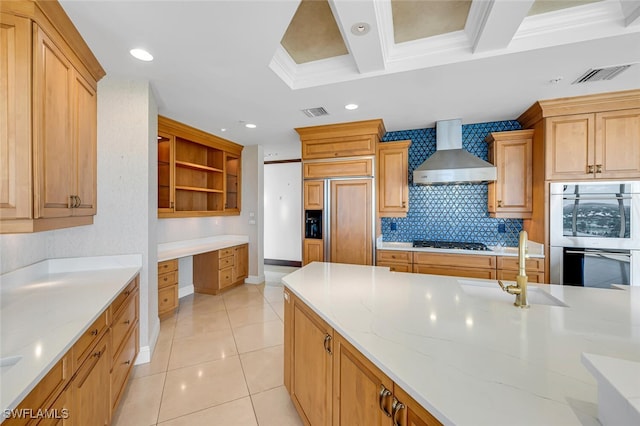 kitchen with open shelves, stainless steel appliances, visible vents, built in study area, and wall chimney exhaust hood