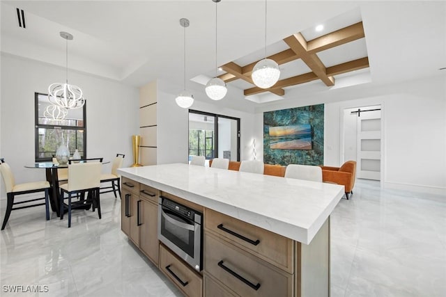 kitchen with coffered ceiling, open floor plan, pendant lighting, and a center island