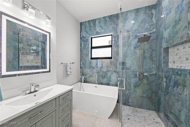 full bathroom with a freestanding bath, a stall shower, and vanity