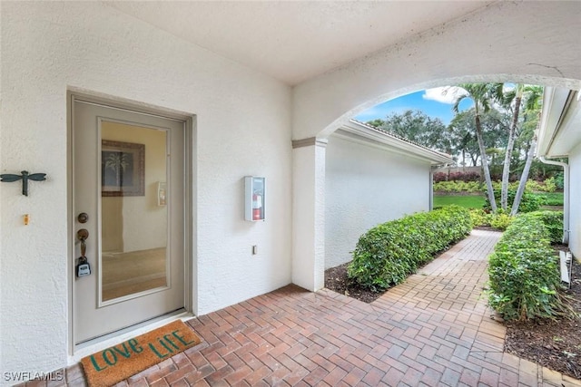 doorway to property with stucco siding