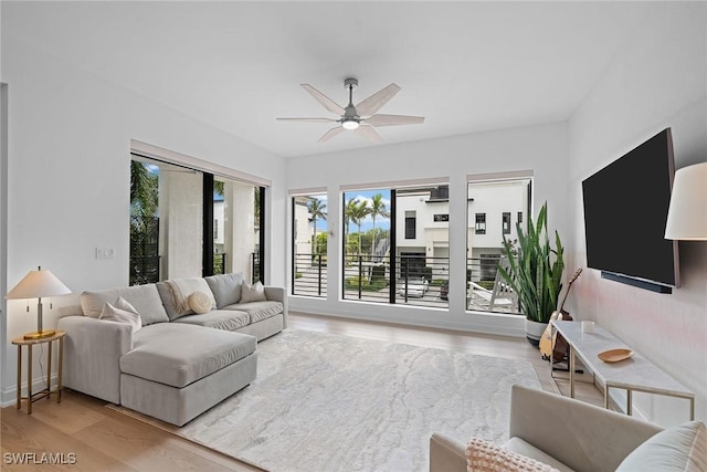 living area featuring a ceiling fan and light wood-type flooring