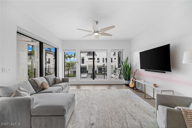 living area featuring a ceiling fan and wood finished floors