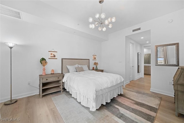 bedroom with light wood finished floors, visible vents, and baseboards