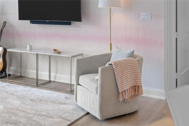 sitting room featuring baseboards and wood finished floors