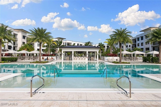 community pool featuring a patio area, fence, and a gazebo