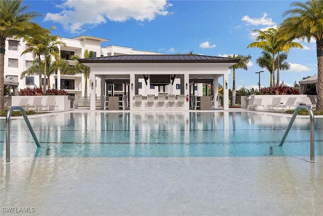 pool with a patio area and fence