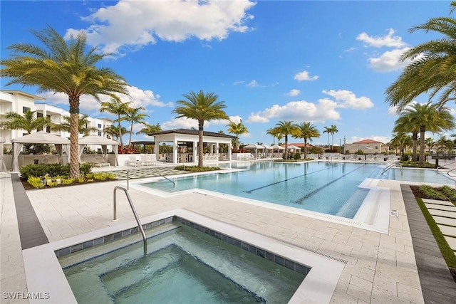 community pool featuring a community hot tub, a patio, and a gazebo