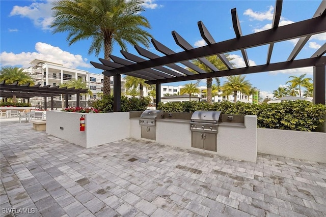 view of patio with an outdoor kitchen, a grill, and a pergola