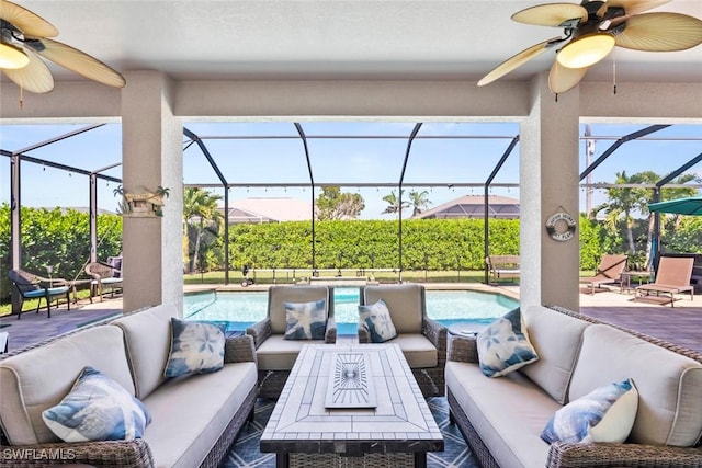 view of patio featuring a lanai, an outdoor pool, an outdoor living space, and ceiling fan