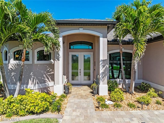 doorway to property with stucco siding and french doors