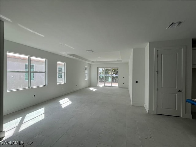 spare room with visible vents, light wood-type flooring, and baseboards