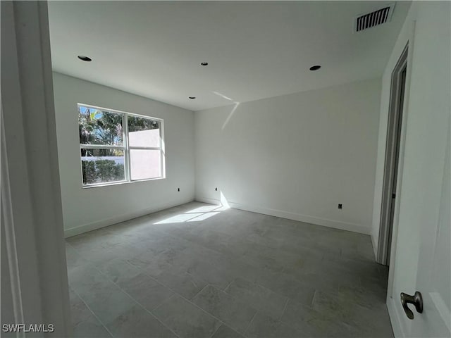 spare room featuring visible vents and baseboards