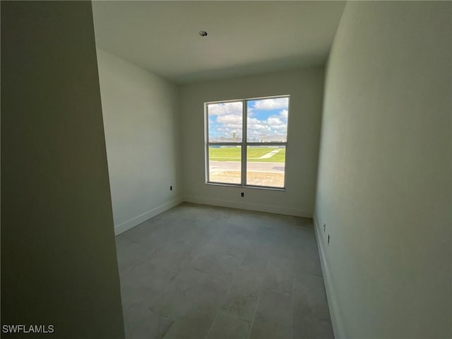 spare room featuring baseboards