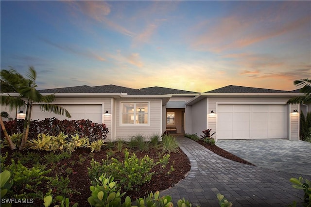 view of front of house featuring an attached garage and decorative driveway