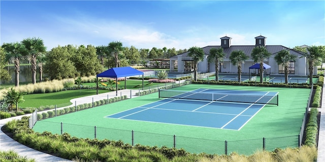 view of tennis court featuring fence