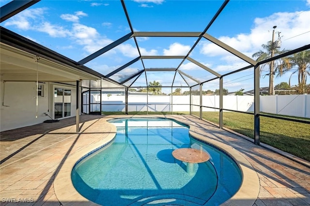 view of swimming pool with a fenced in pool, glass enclosure, a patio area, and a fenced backyard