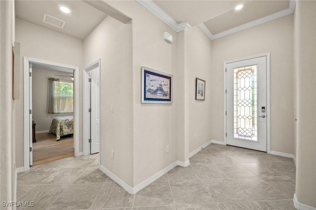 foyer entrance featuring ornamental molding, recessed lighting, visible vents, and baseboards