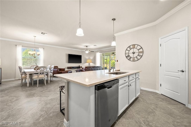 kitchen featuring dishwasher, light countertops, a sink, and a healthy amount of sunlight