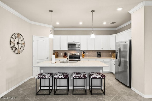 kitchen with visible vents, a kitchen breakfast bar, light countertops, appliances with stainless steel finishes, and decorative backsplash