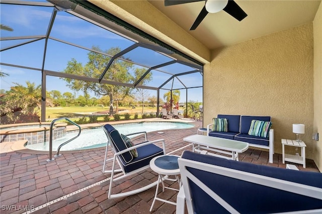 view of patio with an outdoor hangout area, ceiling fan, a lanai, and a pool with connected hot tub