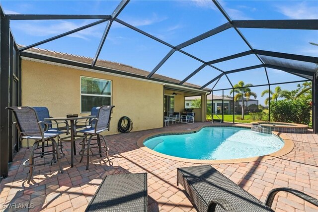 view of pool with a pool with connected hot tub, outdoor dining area, and a patio