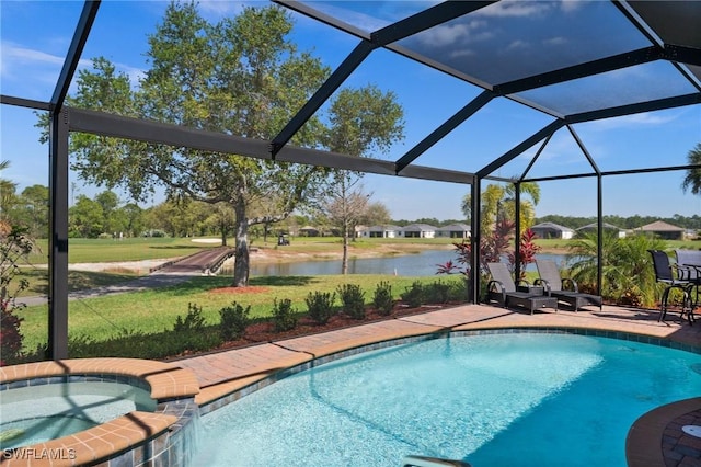 view of swimming pool with a patio, a lanai, a water view, a pool with connected hot tub, and a yard