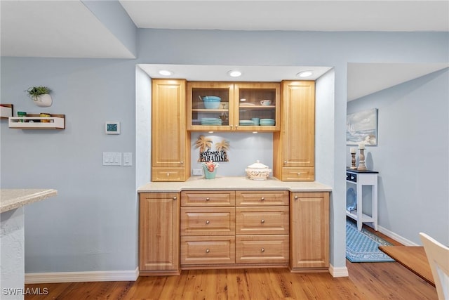 bar with light wood-style flooring and baseboards