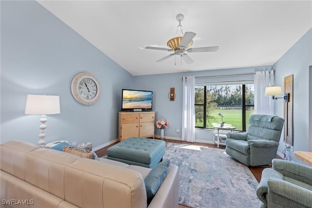 living room featuring baseboards, vaulted ceiling, a ceiling fan, and wood finished floors