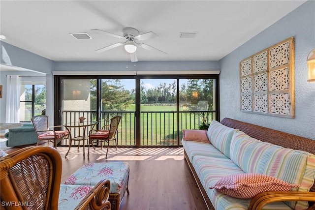 sunroom / solarium featuring ceiling fan and visible vents