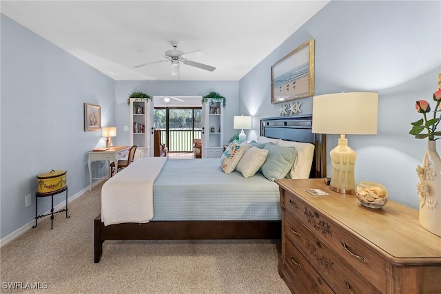 carpeted bedroom featuring access to exterior, ceiling fan, and baseboards