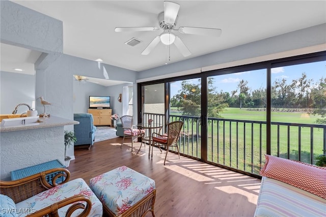 interior space featuring ceiling fan, visible vents, and a sink