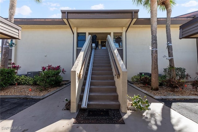 doorway to property with stucco siding