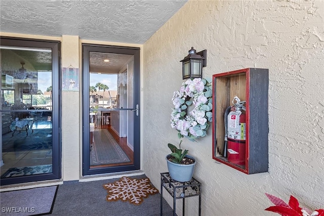 view of exterior entry featuring stucco siding