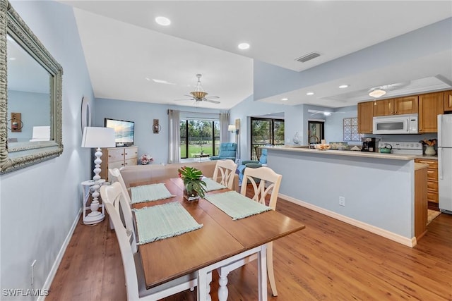 dining space with visible vents, baseboards, a ceiling fan, light wood-style flooring, and recessed lighting