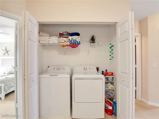 laundry room featuring light carpet, laundry area, baseboards, and separate washer and dryer