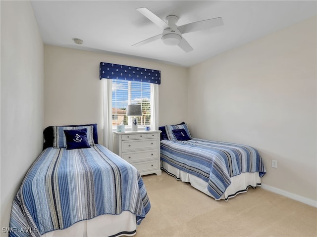 bedroom with light carpet, a ceiling fan, and baseboards