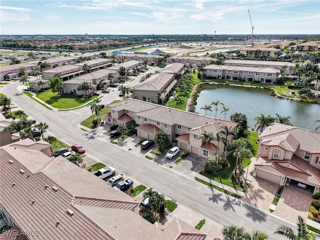 drone / aerial view with a water view and a residential view