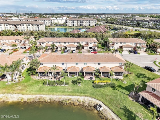 birds eye view of property with a water view and a residential view