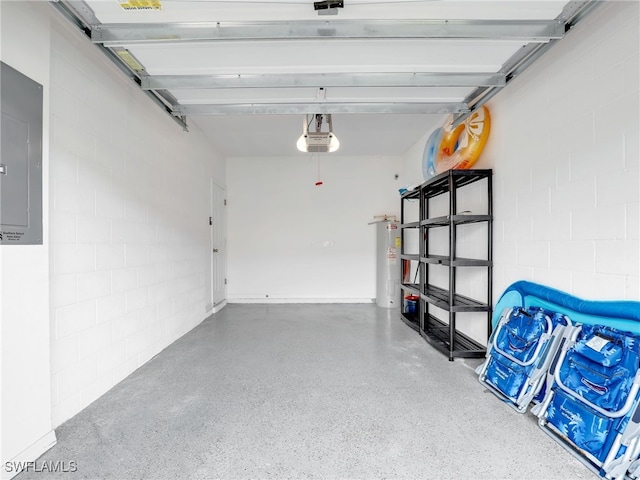 garage with electric panel, concrete block wall, water heater, and a garage door opener