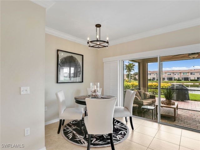 dining space featuring a chandelier, crown molding, baseboards, and tile patterned floors