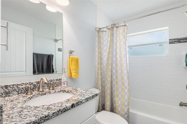 full bathroom with vanity, toilet, and shower / tub combo with curtain