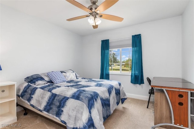 bedroom with baseboards, a ceiling fan, and light colored carpet