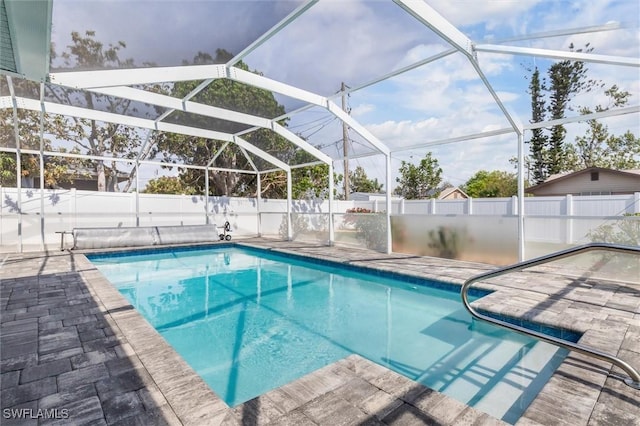 view of swimming pool featuring a lanai, a patio area, a fenced backyard, and a fenced in pool