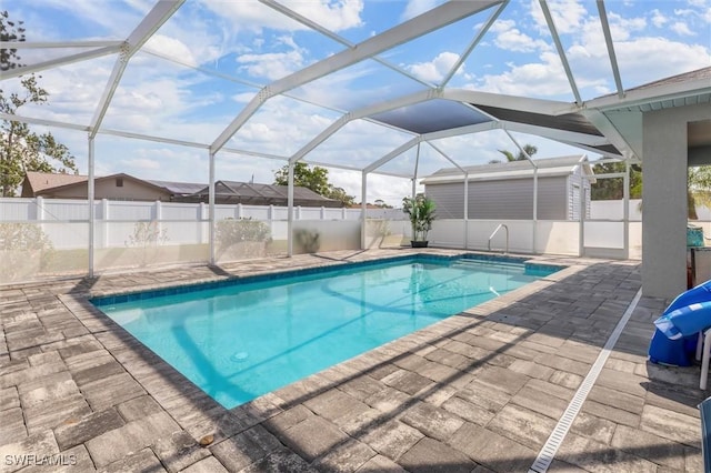 view of swimming pool with a patio, a lanai, a fenced in pool, and fence