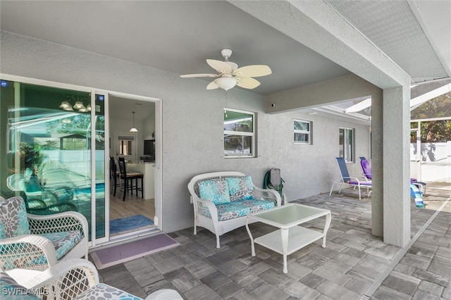 view of patio featuring a ceiling fan and a lanai