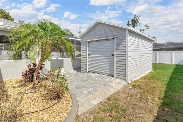 garage featuring a shed and fence