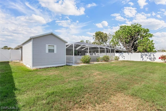 exterior space with a lanai and a fenced backyard