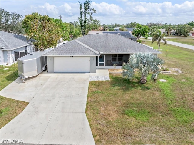 ranch-style home featuring a garage, driveway, roof with shingles, and a front yard