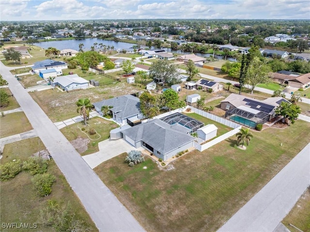 birds eye view of property with a water view and a residential view