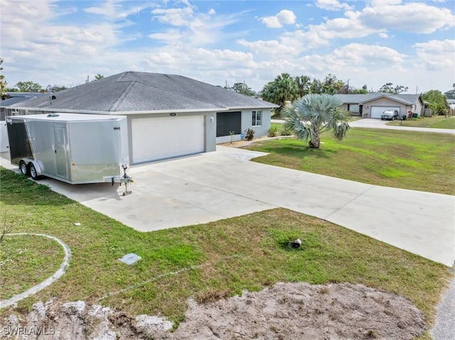 single story home with concrete driveway, an attached garage, a front lawn, and stucco siding